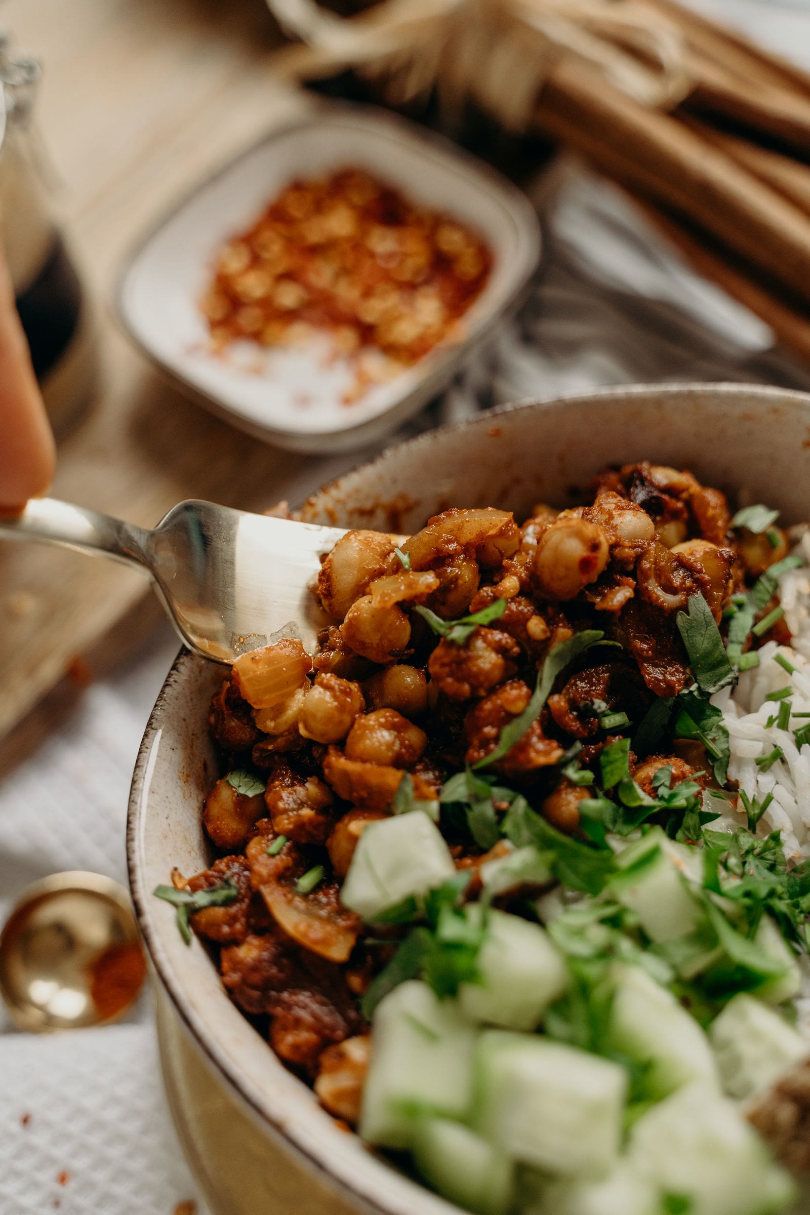 Bowl of chickpeas, cucumber, greens, and grains