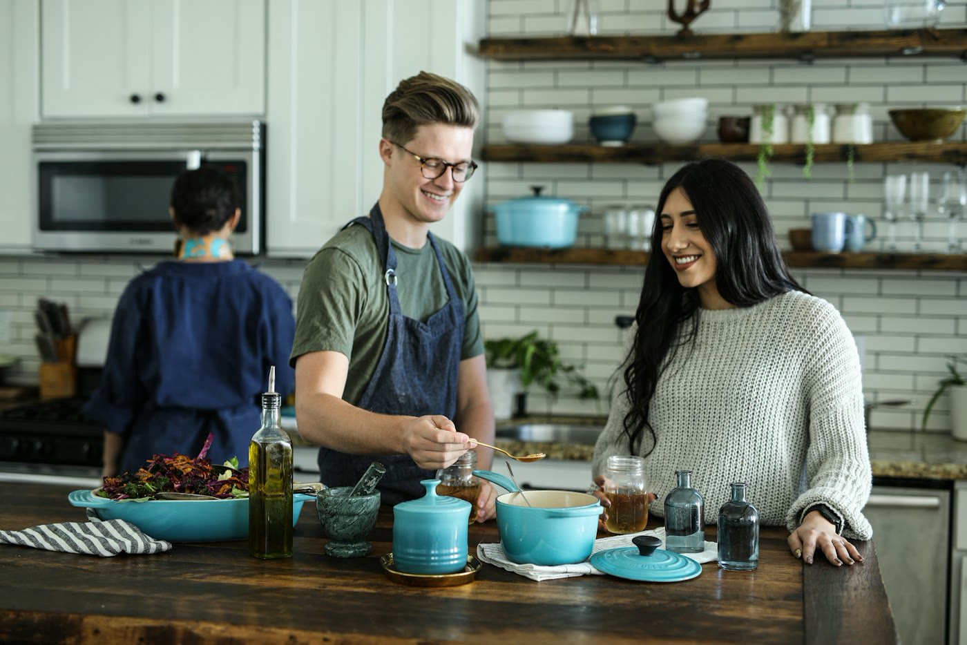 Friends cooking a meal together in a home kitchen